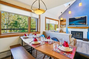 Open Dining and Living Area - Dining area overlooking the living room and fireplace, creating an open and inviting space for gathering.
