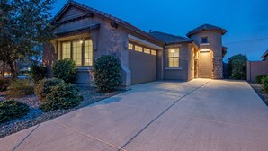 A residential house with a driveway, a garage, and a small tower-like structure. - Peaceful Location w/Sunset & Wildlife Views, Htd Pool, Hot Tub, Fire Table, 2 Bikes (Gold Canyon)