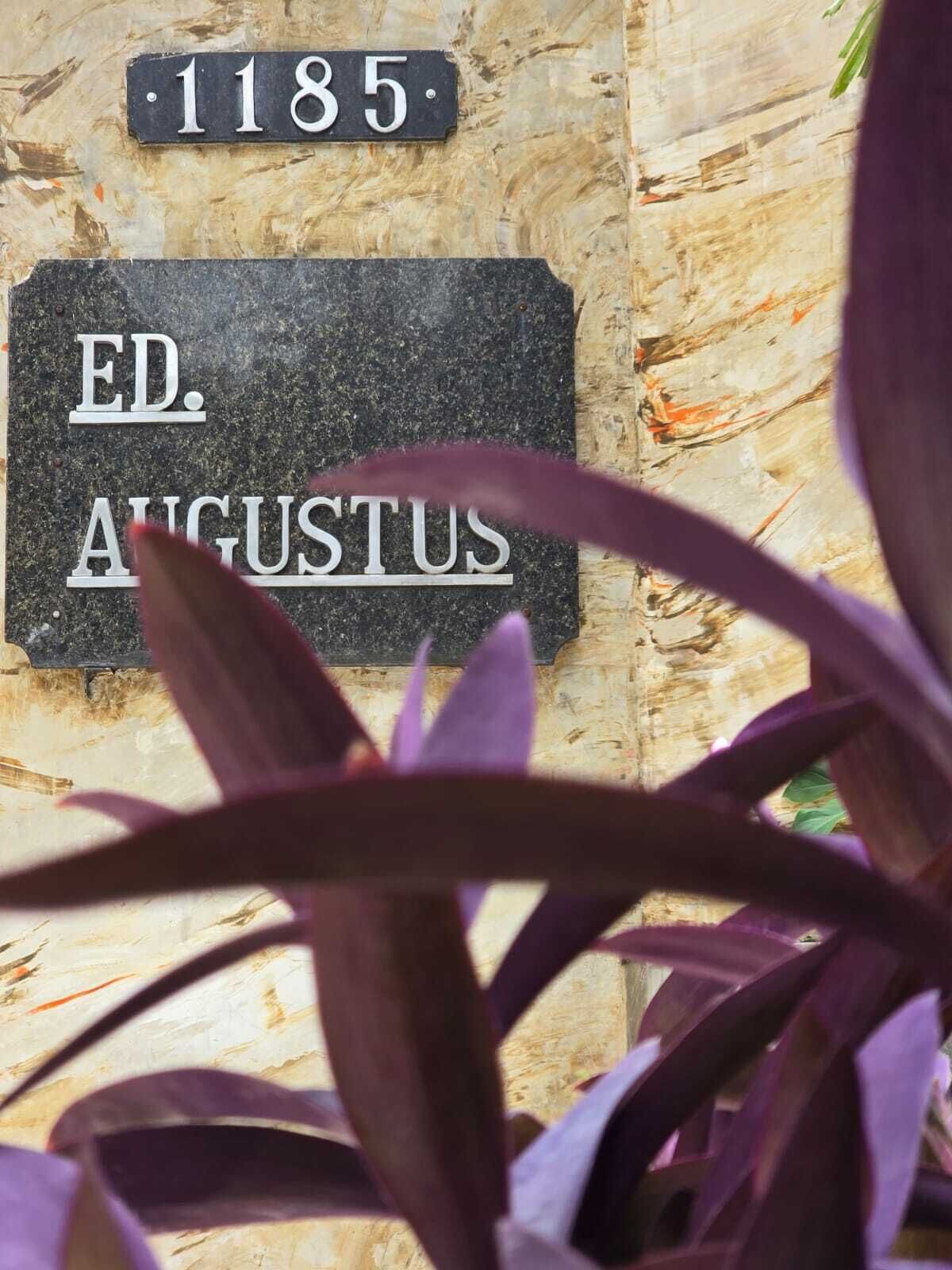 A plaque with 'ED. AUGUSTUS' and a number '1185' on a wall.