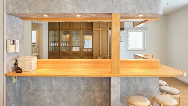 A modern kitchen with wooden cabinets, a wooden countertop, and a built-in seating area. - Hoshiyado Asahikawa asahimachi (Asahikawa)