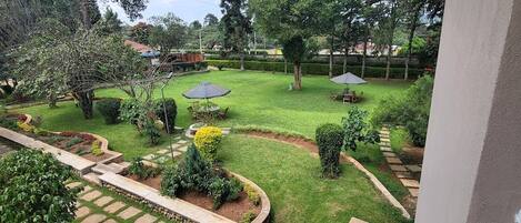 A well-maintained garden with a lawn, pathways, and seating areas.
