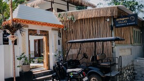 A building with a sign reading "28 Degrees Villas" and a golf cart parked in front. - 28 Degrees Lembongan (Lembongan Island)