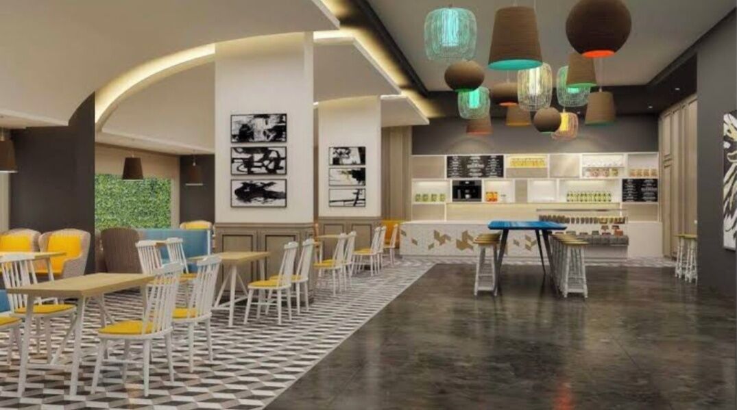 A modern cafe with a checkered floor, white and yellow chairs, and a bar area with shelves.