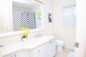 A modern bathroom with a white vanity, a sink, and a toilet. - Cozy 3BR Villa w/ Poolside Gym, AC & WiFi near Ocho Rios (Ocho Rios)