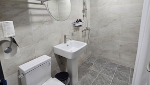 A modern bathroom with a toilet, sink, and shower. - BonghwangINN BonghwangMansion2 (Gyeongju)