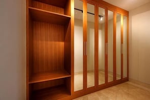 A wooden wardrobe with multiple doors and shelves. - Trisha Cliff Villa by Parigata (Bali)