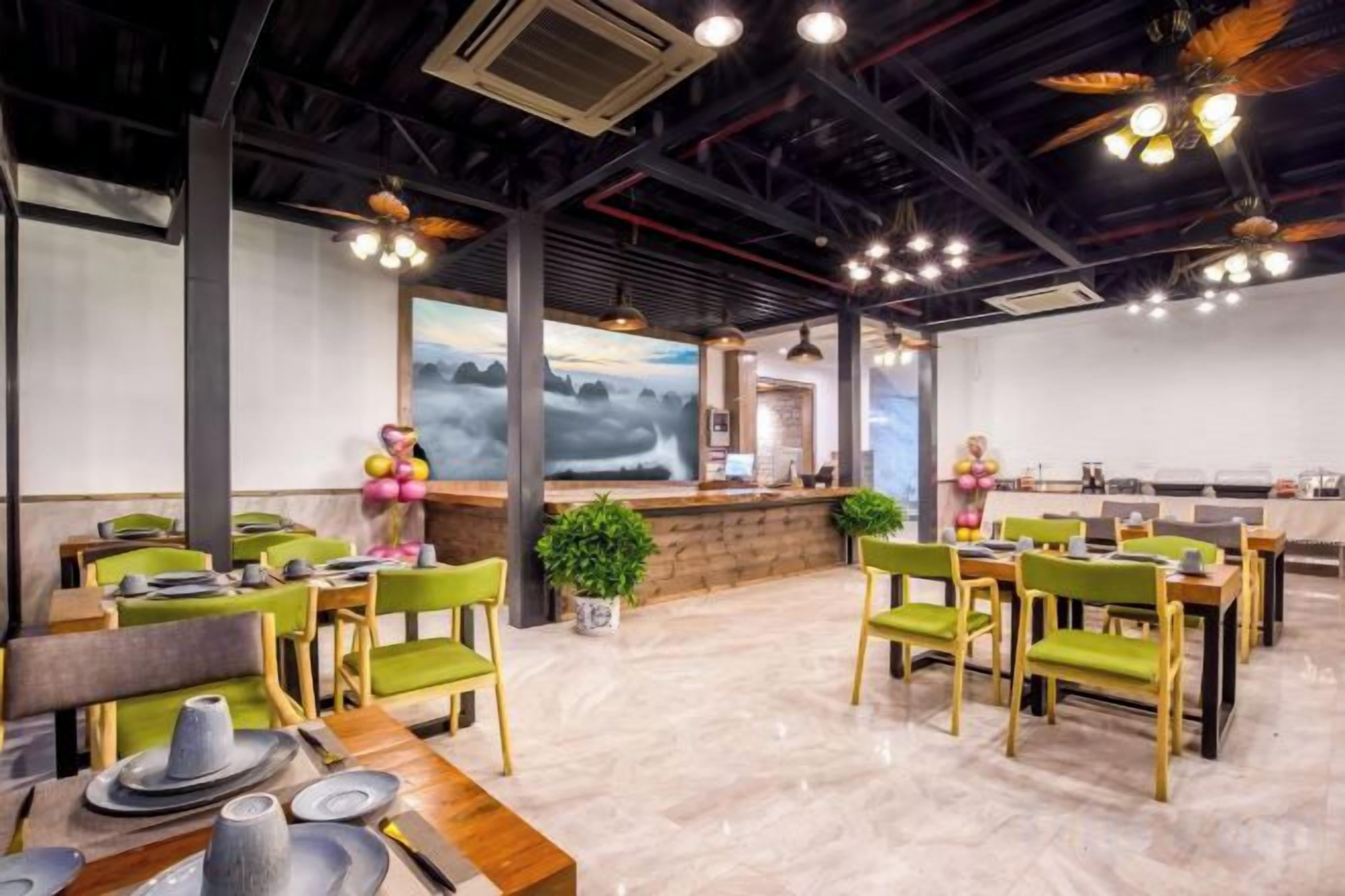 A restaurant with round tables and chairs, a bar area, and a large window with a view.