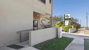 The exterior of the Blackwater Central Hotel with a reception area, a staircase, and a signboard.