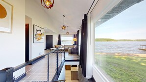 A modern interior with a staircase, a view of the water, and a dining area. - Grandview Luxe Retreat - Gravois Arm (Gravois Mills)
