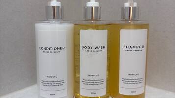 Three bottles of Arder Premium products on a shelf.