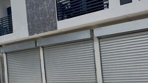 A modern building with a flat facade, large windows, and closed shutters. - Bello Heaven Juayua! (Juayua)