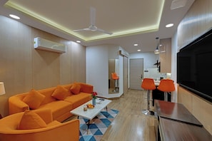 Junior Suite | Living area | 32-inch flat-screen TV with cable channels - AR Suites Sohna Road (Gurugram)