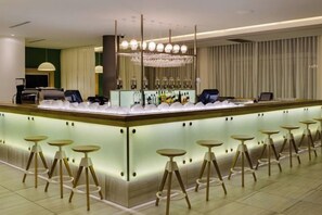 A bar area with stools, a counter, and a chandelier. - Protea Hotel Fire & Ice! Cape Town (Cape Town)