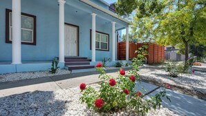 A house with a blue exterior, white columns, and a front porch. - Walk to UC Davis Medical Center! Duplex w/ Patio (Sacramento)