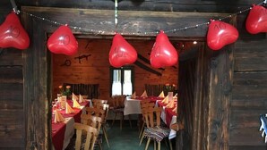 A rustic dining area with wooden walls and tables set for a meal. - Waldrestaurant Vida  (Kapfenberg)