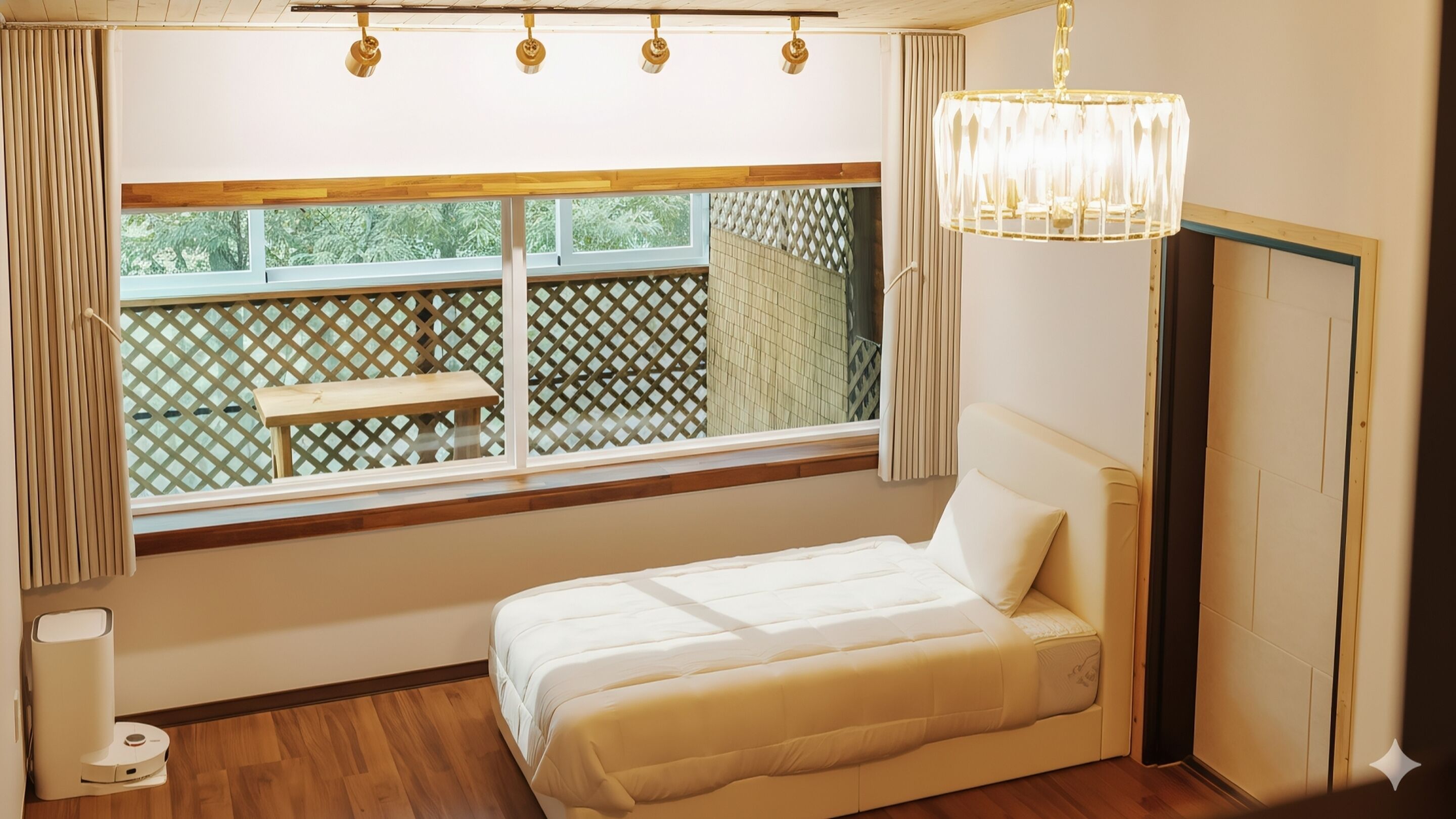 A bedroom with a bed, a window, a chandelier, and a view of an outdoor deck.