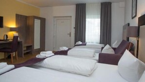A hotel room with a bed, a desk, a chair, and a wardrobe. - Trip Inn Goethe Hotel Messe Frankfurt (Frankfurt)