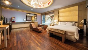 A hotel room with a large bed, a desk, a chair, a small table, and a ceiling light fixture. - From H Amoremio The Classic Suwon (Suwon)