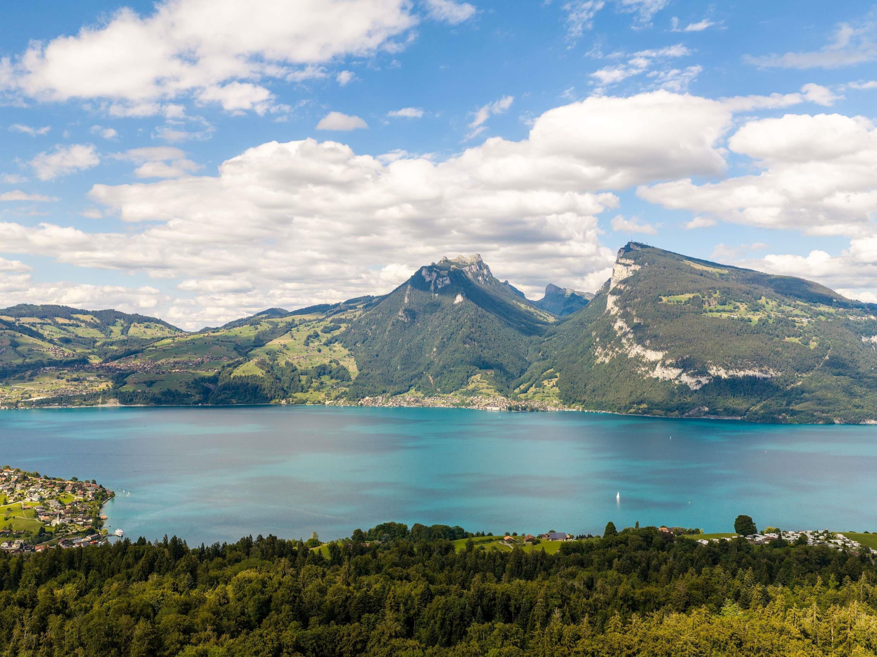 A mountainous landscape with a lake and a village.
