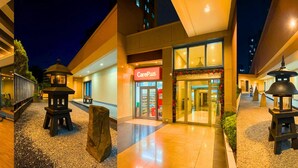 A hotel entrance with a CarePlus sign, a well-lit pathway, and traditional lanterns. - Sea Family Room in Front of US Embassy (Manila)