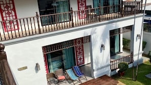 A two-story building with a balcony, outdoor seating, and a small pool. - Taurus Villa10 Bedrooms with Private Pool. (Pattaya)