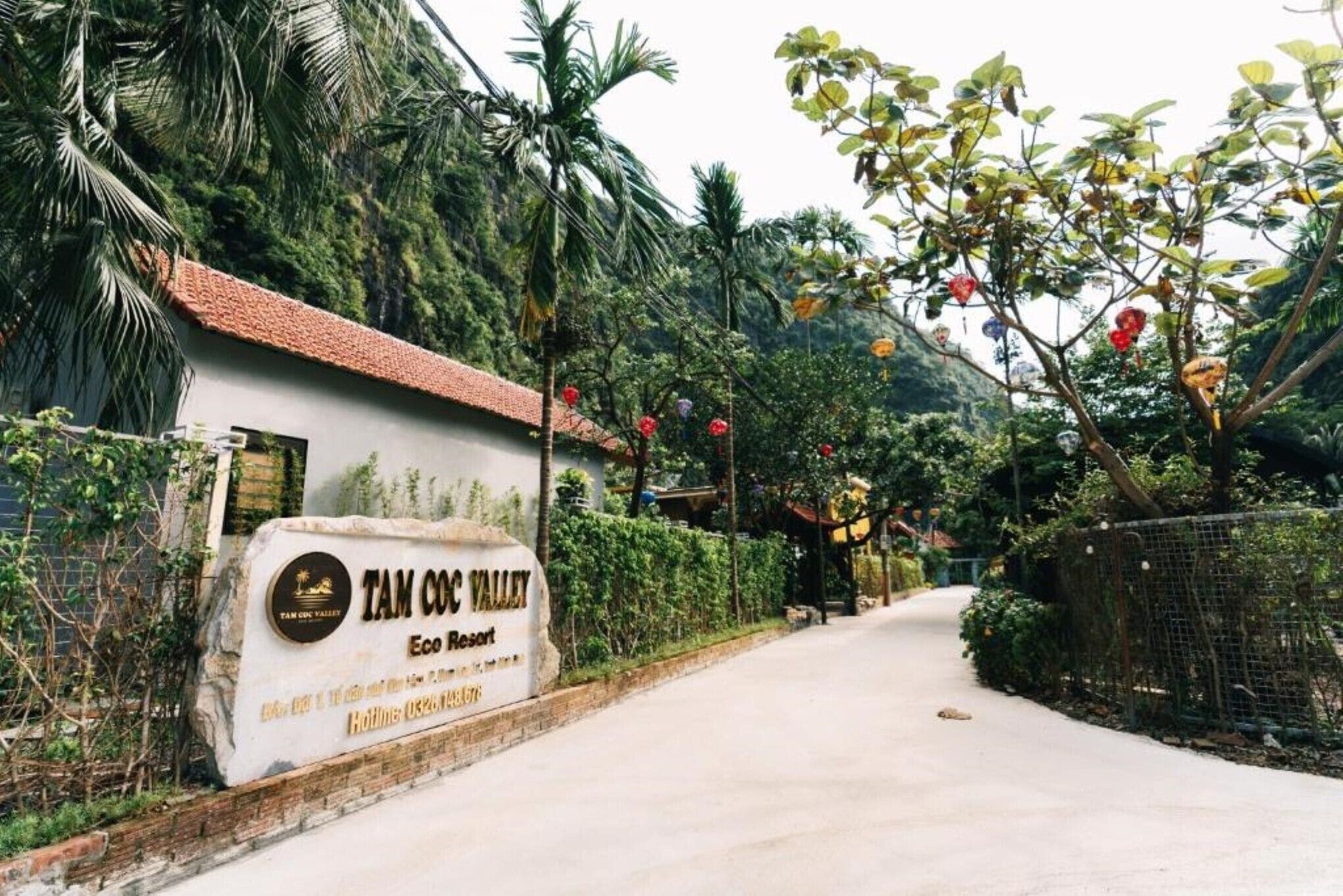 A sign for Tam Coc Valley Eco Resort with a paved pathway leading to the entrance.