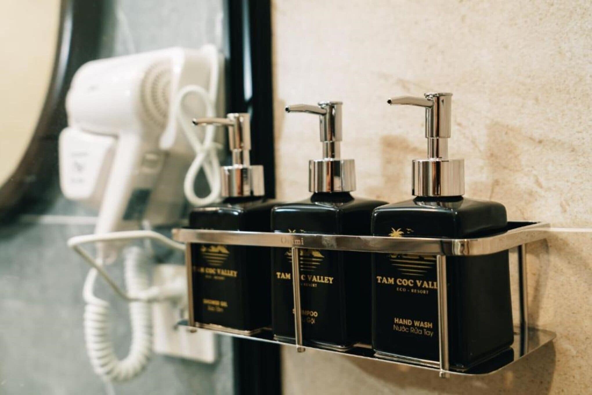 A bathroom with a hand wash station and a phone.