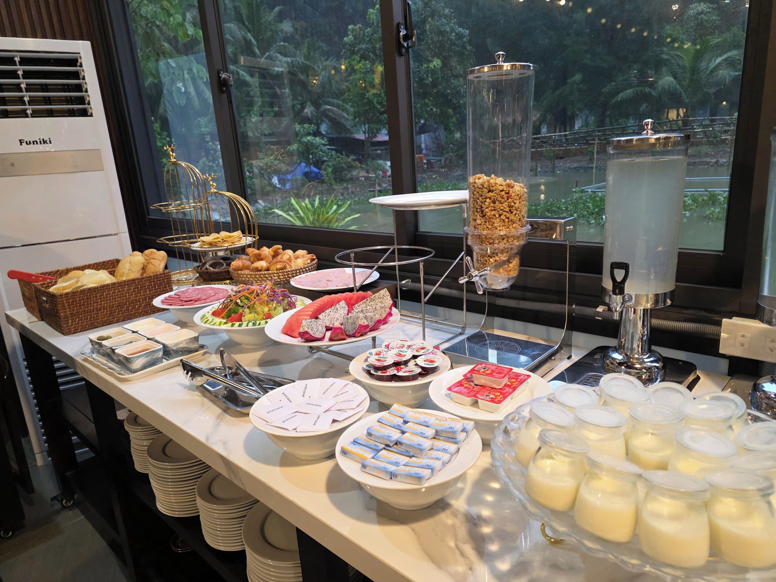 A buffet with various food items, including pastries, salads, and dairy products.
