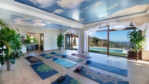 A spacious yoga room with large windows, a ceiling mural, and multiple yoga mats. - Geroulios Kastro Villa II-Heated* Pool & Jacuzzi (Chania)