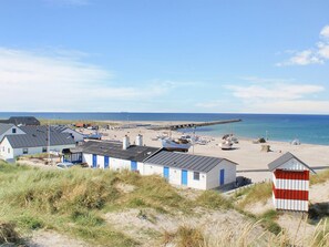 A coastal village with small houses, a pier, and boats on the beach. - "Gisa" - 500m from the sea by Interhome (Thisted)