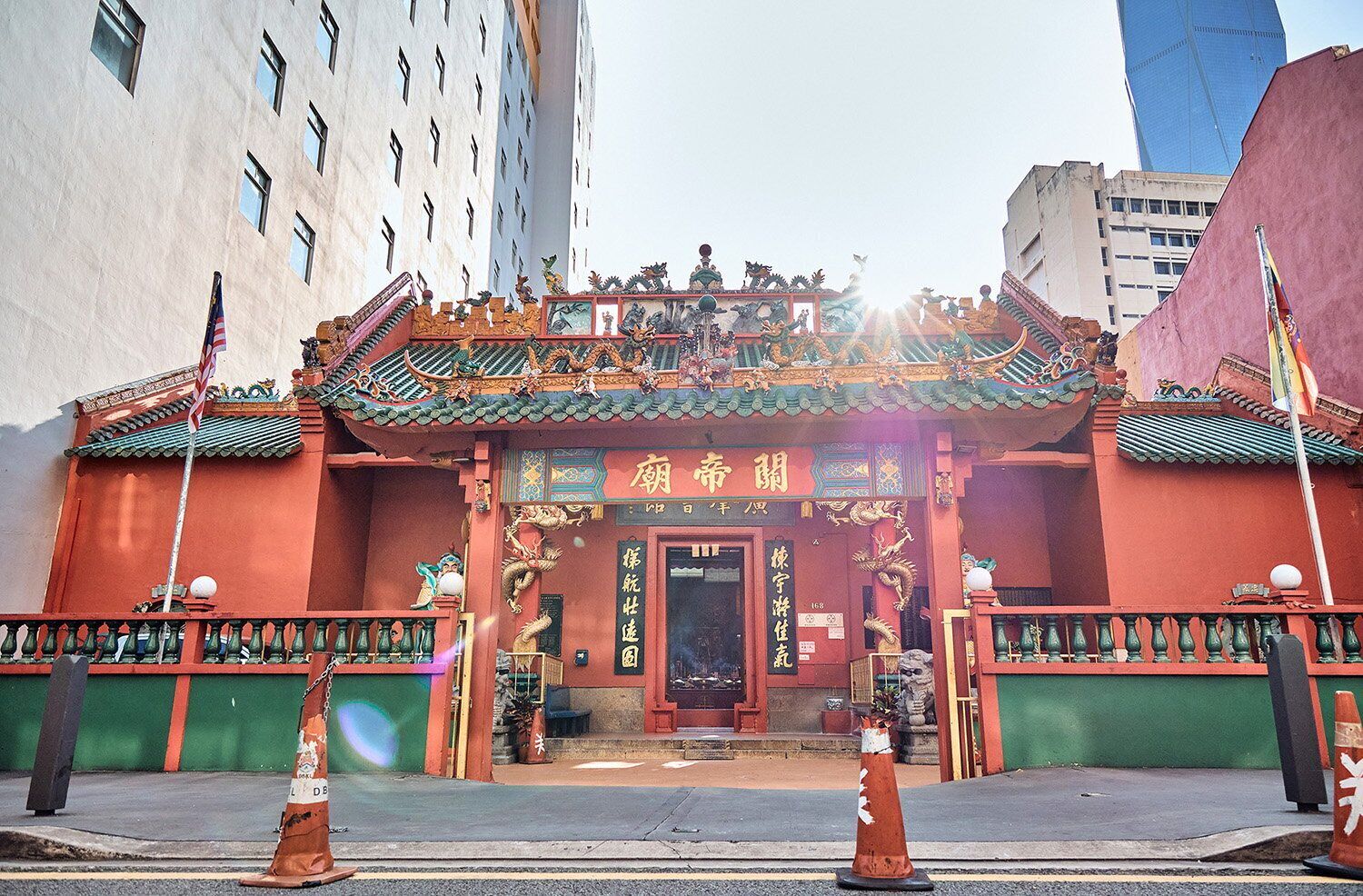 A traditional Chinese building with ornate architecture, including a red entrance and green roof tiles.