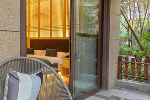 Terrace/patio - Heinemann Hotel courtyard or terrace king room A206— with a jacuzzi and a local (Leshan)