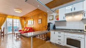 A kitchen with white cabinets, a built-in oven, and a granite countertop.