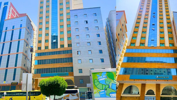 A modern hotel with a prominent blue facade, multiple floors, and a mix of glass and brick construction. - vivyan al Gemmayzeh  (Makkah)