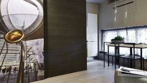 A modern interior with a dining area featuring a table and chairs, a wall-mounted light fixture, and a large window with curtains. - Luxury Design Apartment Downtown - FREE PARKING (Milano)