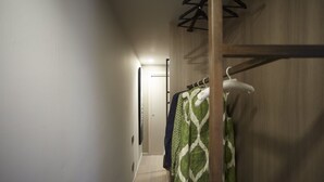A narrow hallway with a wooden wardrobe and a coat rack. - Luxury Design Apartment Downtown - FREE PARKING (Milano)