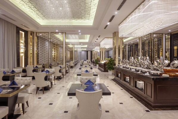 A hotel lobby with a long buffet line, plush seating, and a decorative ceiling. - MeliĆ” Vinpearl Hai Phong Rivera (Hai Phong Municipality)