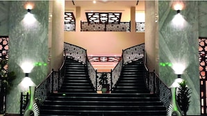 A grand staircase with intricate railings, leading to a higher floor. - AlFajr AlBadie Hotel 1 (Makkah)