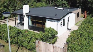 A modern building with a flat roof, a visible entrance, and a sign that reads "FOKKEMAAT". - Fokkemaat - Modern family home with large garden, close to the beach and town center (Callantsoog)