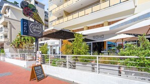 A modern building with a sign for Gelato Mania and SOHO Work Space. - Greenpark 202 (Cape Town)