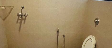 A small, compact bathroom with a toilet, bidet, and sink.