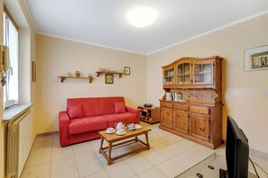 Family House, Multiple Bedrooms (Maison Dolce Vento) | Living area | 21-inch flat-screen TV with cable channels