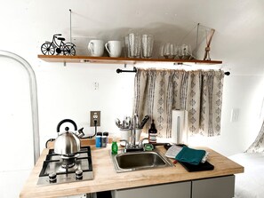 Fridge, stovetop, coffee/tea maker, cookware/dishes/utensils