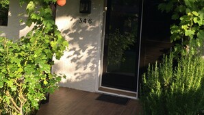 A building with a number '346' on the wall, a door, and a window.