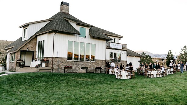 A two-story house with a stone facade and large windows. - Breathtaking Cottage with Hot-tub in Eagle Mountain, Utah (Eagle Mountain)