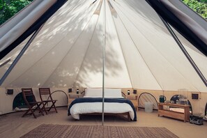 A tent with a bed, chairs, and a table. - Cute Bell Tent in Carson for Columbia Gorge Glamping in Washington (Carson)