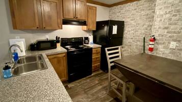 Fridge, coffee/tea maker, cookware/dishes/utensils, dining tables