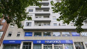 A multi-story building with 'euronics' signage on the ground floor.