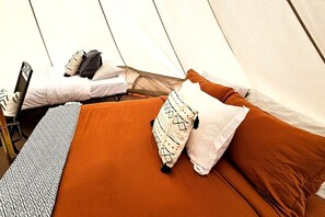 A tented accommodation with two beds, each with pillows and a blanket. - Stunning Family Glamping Tent for a True Outdoor Experience on a Secluded Ranch in Moab, Utah (Moab)