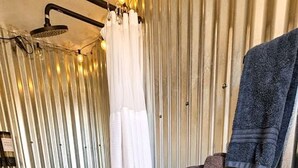 Ein kleines Badezimmer mit Toilette, Dusche und Handtuchhalter.
